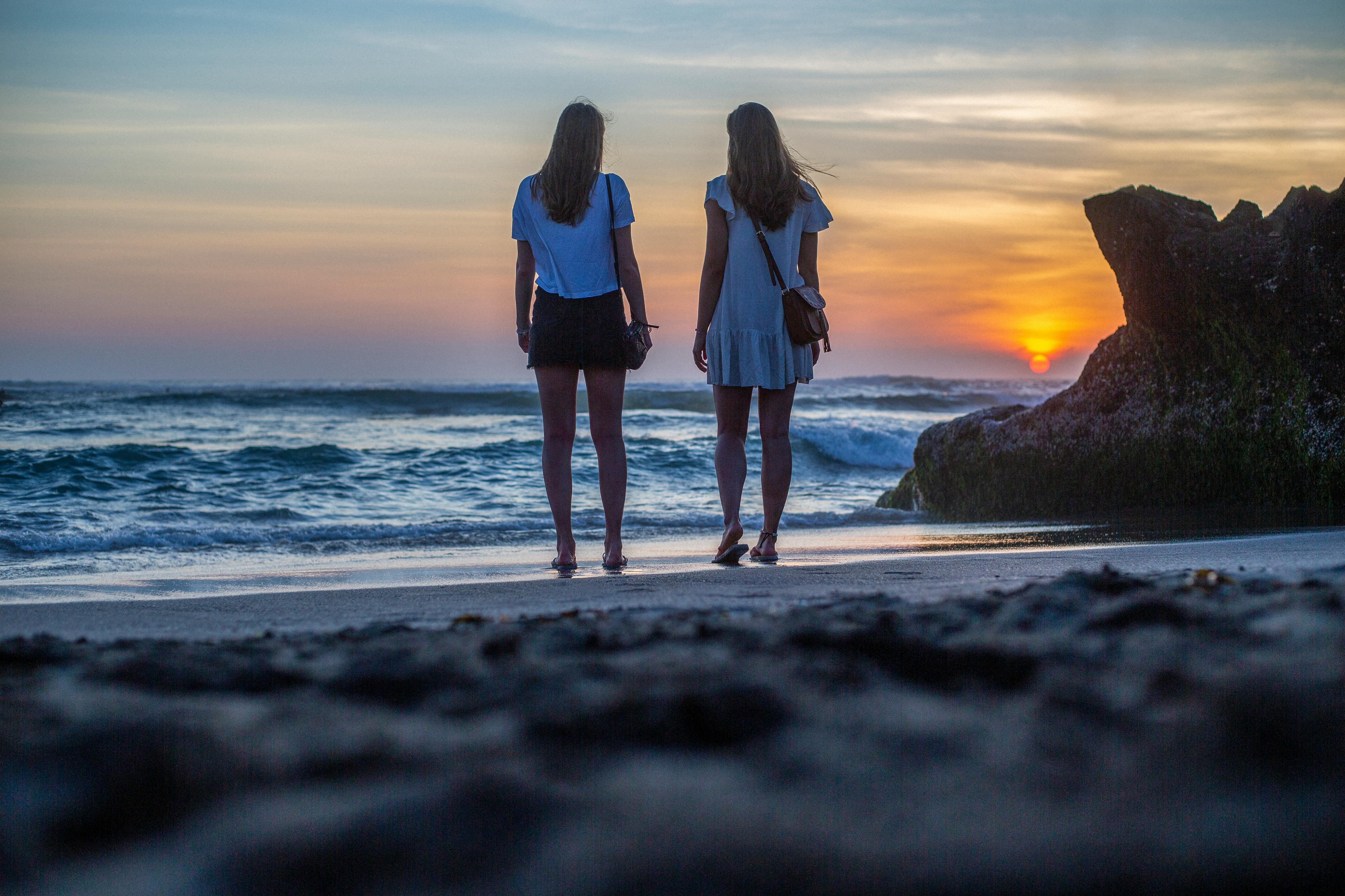 support a women through a breakup - 2 women on the beach walking