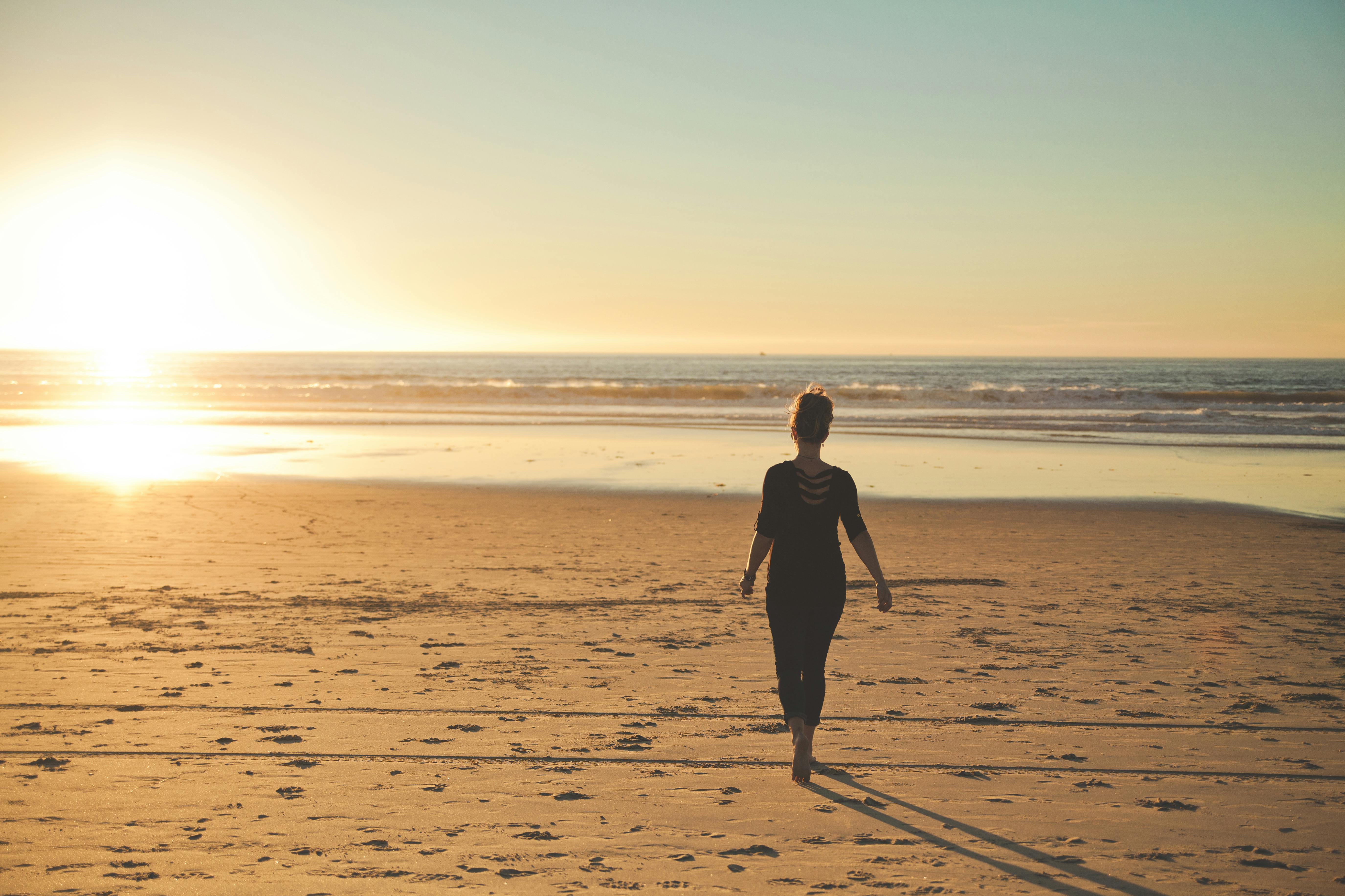 how to come back after a breakup - a women walking on the beach